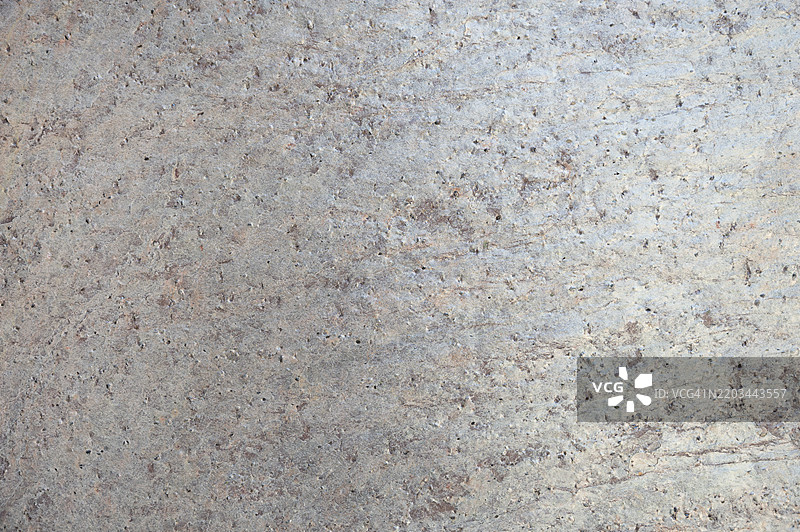 带有几个小孔的灰色和棕色表面图片素材