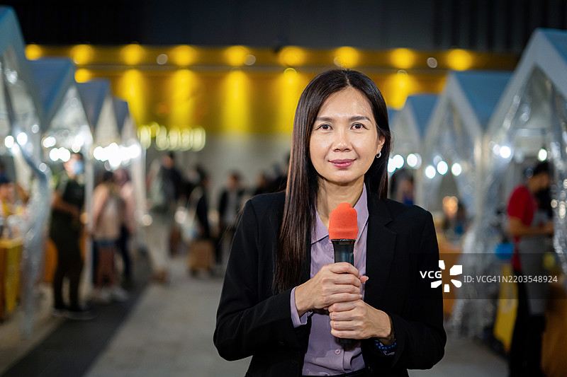 夜间户外报道的电视记者图片素材