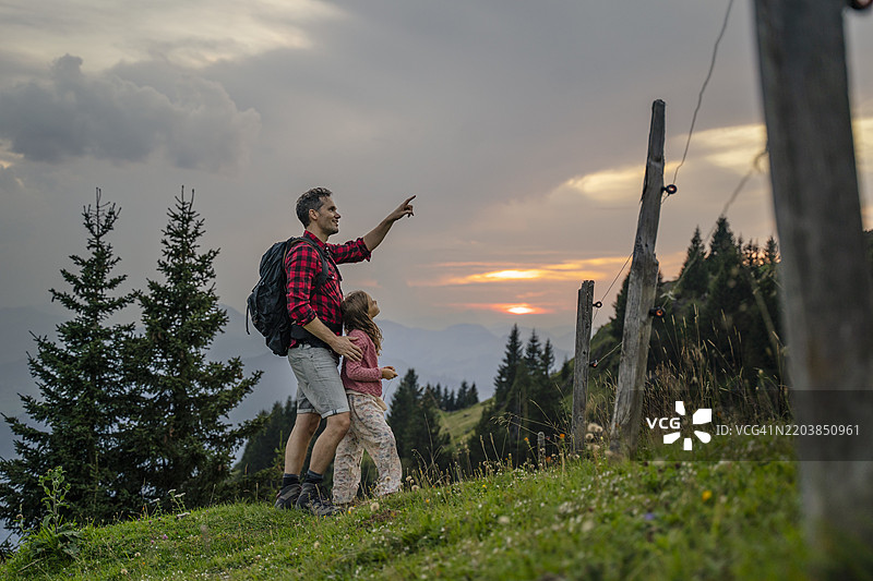 父亲与女儿一起散步，并指向天空图片素材