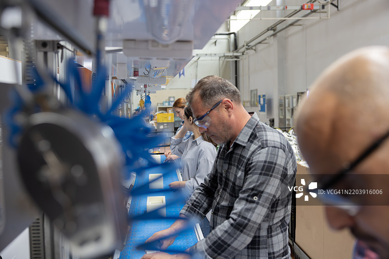 工厂生产线上的一组工人正在工作图片素材