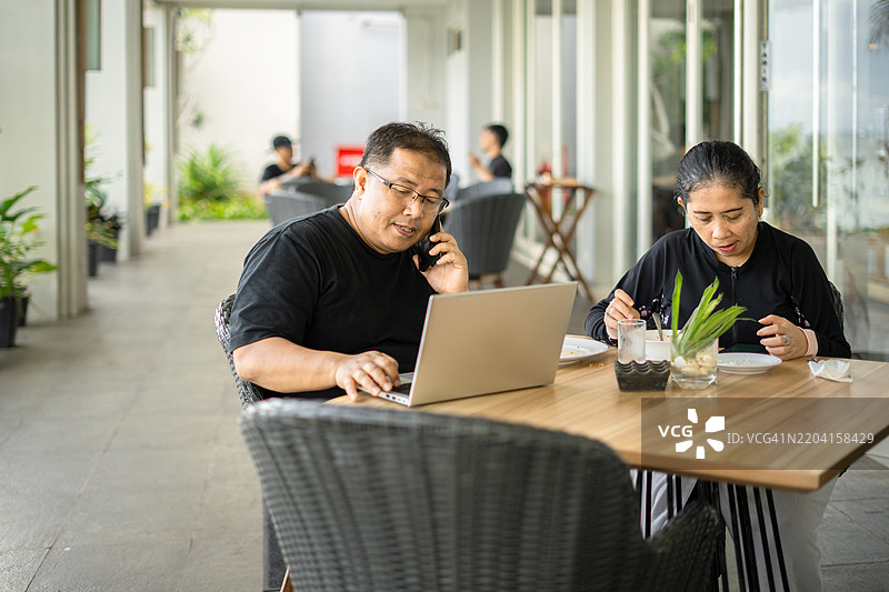 商人在度假期间与妻子一起工作图片素材