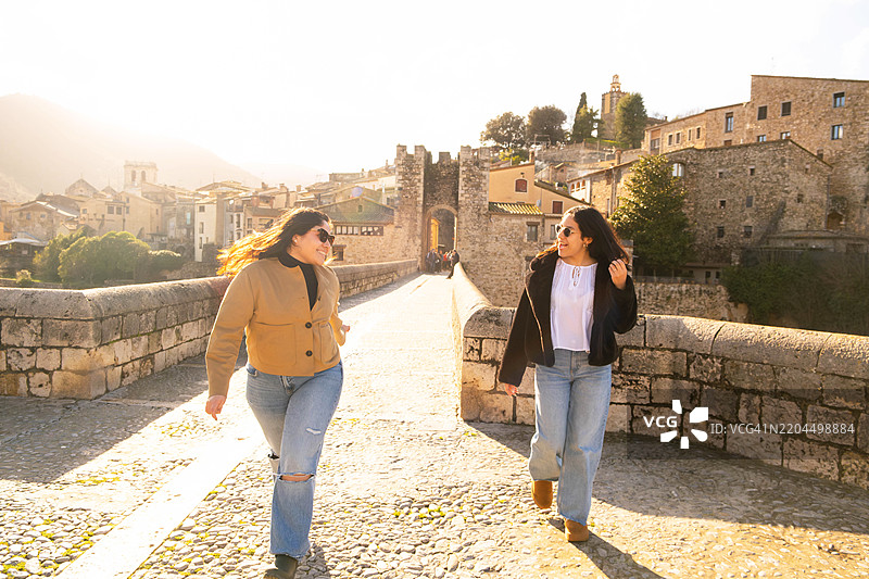朋友们在阳光明媚的加泰罗尼亚度过冬季假期，探索中世纪小镇图片素材