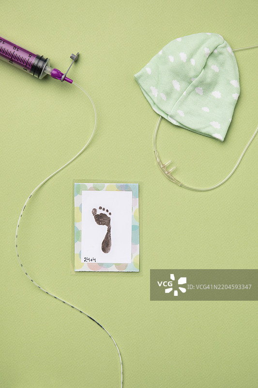 绿色背景上的医疗设备、帽子和足迹图片素材