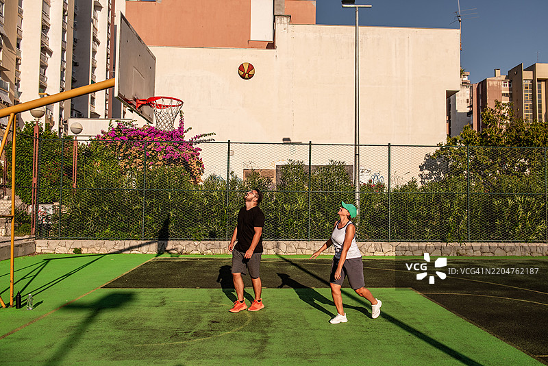 一对情侣在住宅区户外打篮球图片素材