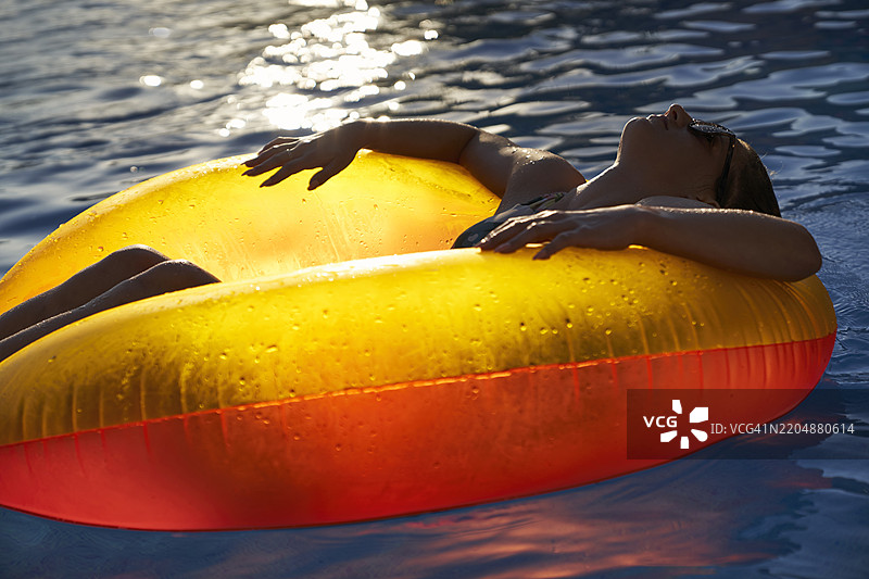 日落时在泳池中放松图片素材