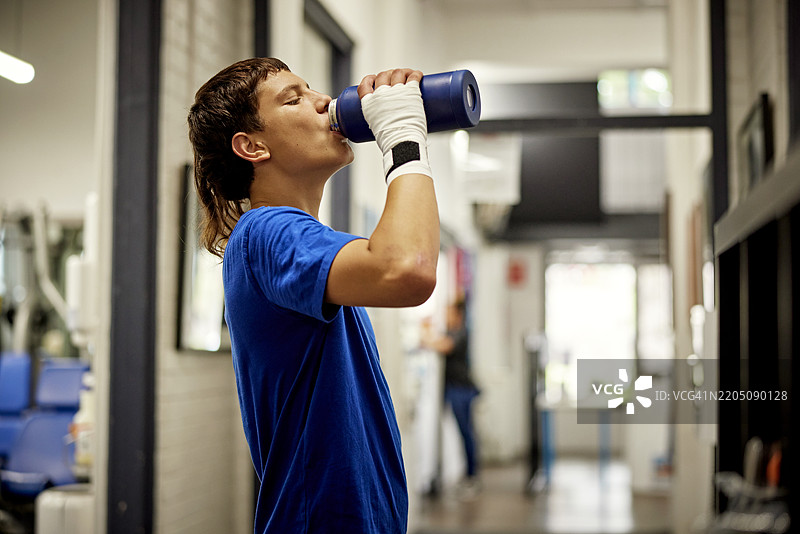 青少年拳击手在青年俱乐部解渴图片素材