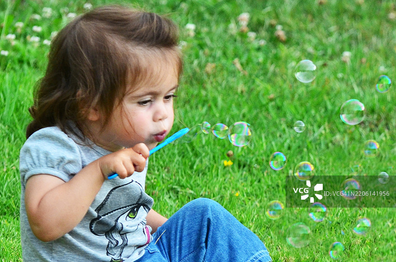 小女孩在吹肥皂泡泡图片素材
