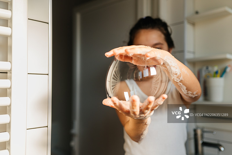 快乐女孩在浴室里玩肥皂泡泡图片素材