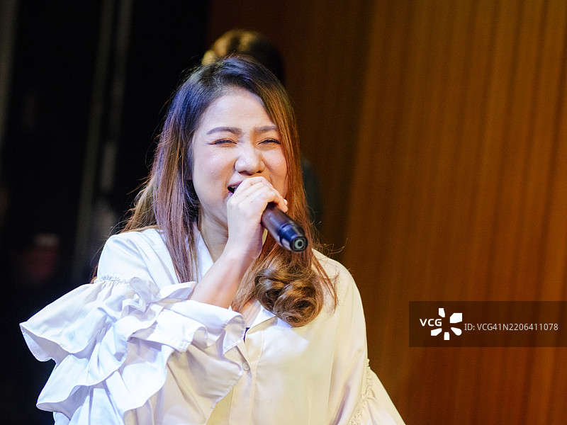 快乐的泰国女歌手在表演图片素材