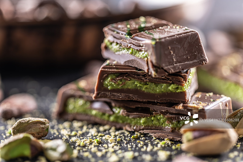 迪拜巧克力棒配绿卡达伊夫和开心果酱，撒上开心果仁 - 特写图片素材
