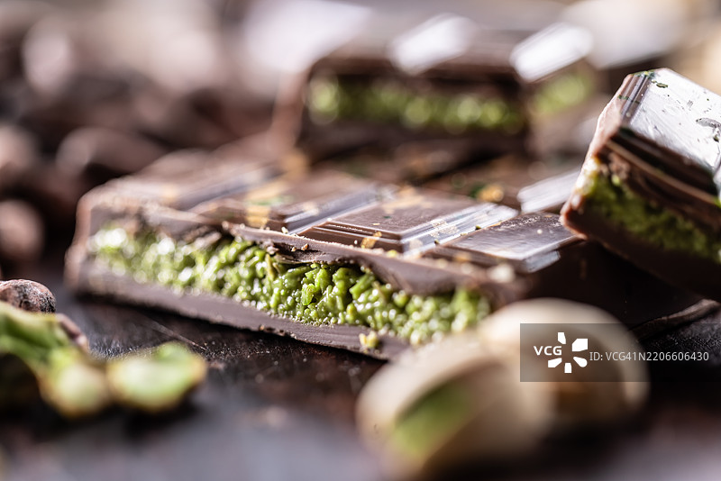 迪拜巧克力棒，配有绿色卡达伊夫和开心果酱，撒上开心果仁 - 特写镜头图片素材