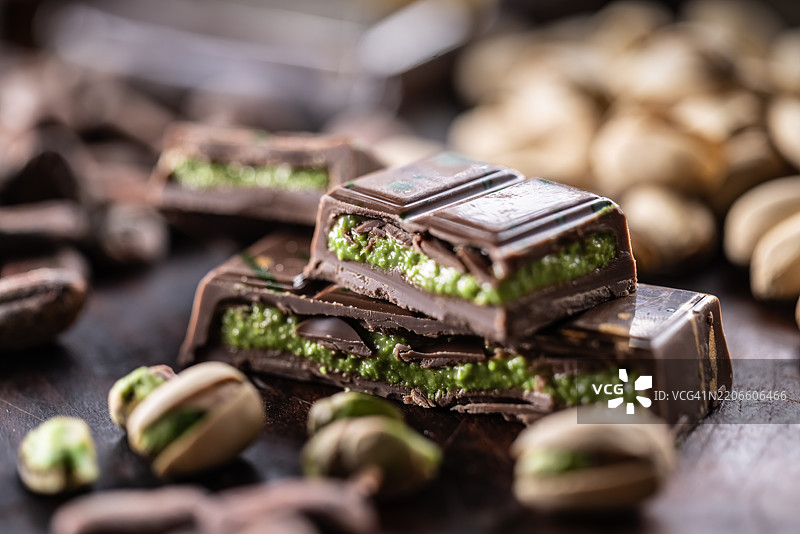 迪拜巧克力棒，配有绿色卡达伊夫和开心果酱，撒上开心果仁 - 特写镜头图片素材