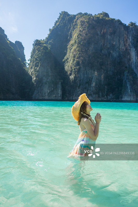 泰国科洪：一位女士站在水中，凝视着地平线图片素材