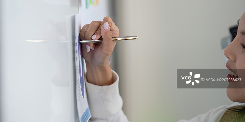 在白板上专业地书写，同时讨论财务问题图片素材