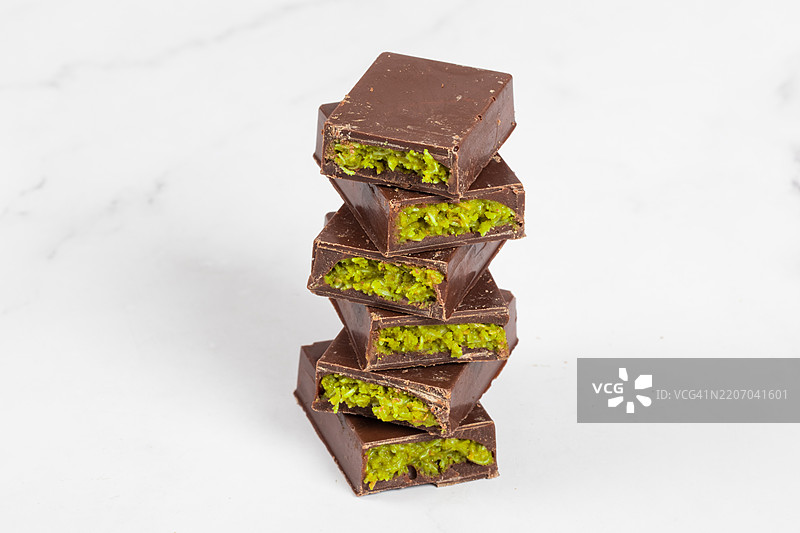 迪拜巧克力配脆皮卡塔菲面团和翡翠开心果酱。特写。白色背景图片素材