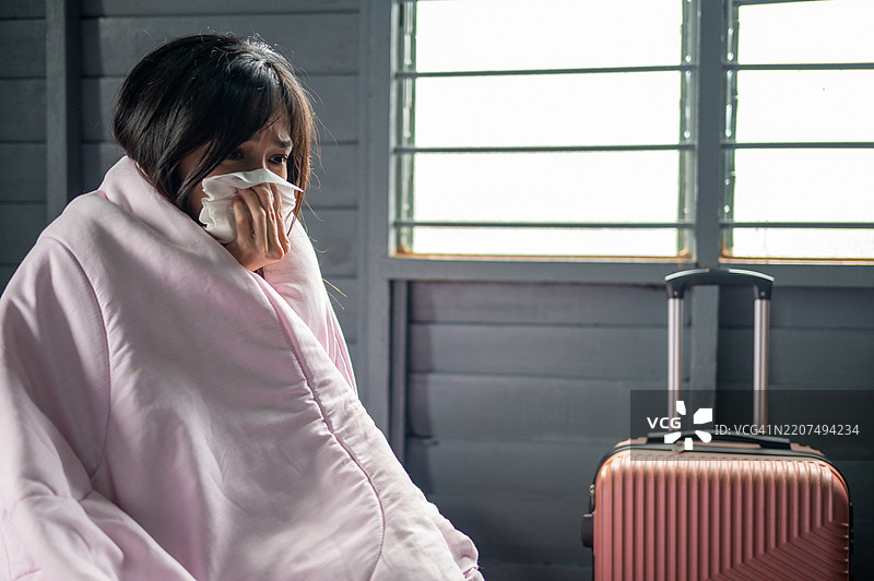 裹在毯子里的旅行者：不适的时刻图片素材