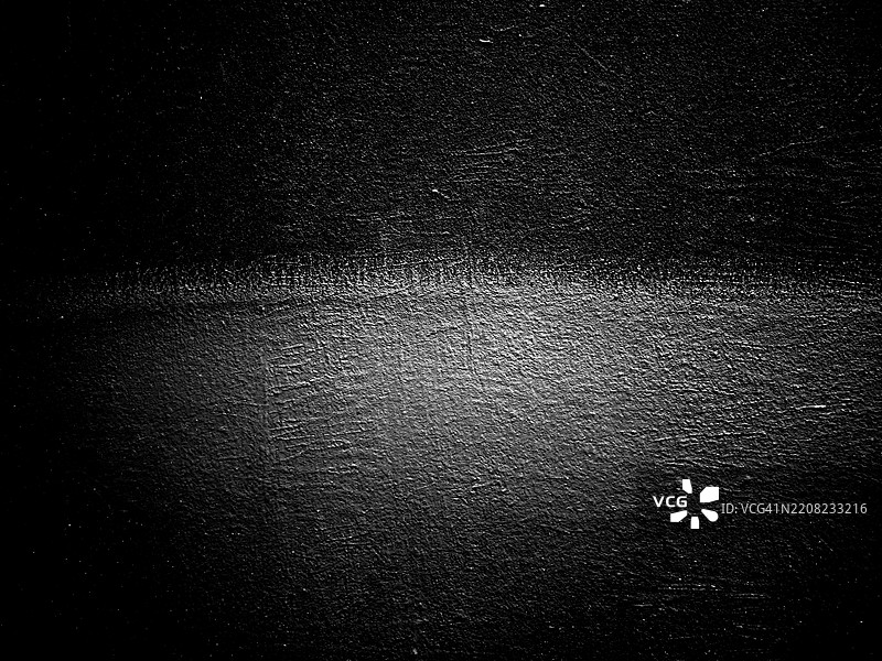 黑墙上灰色油漆的特写。粗糙的纹理。阳光。黑白。法国巴黎。图片素材