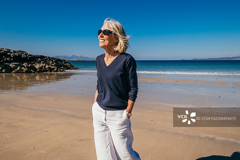 苏格兰阿里赛格的卡穆斯达拉赫海滩上行走的女人。图片素材