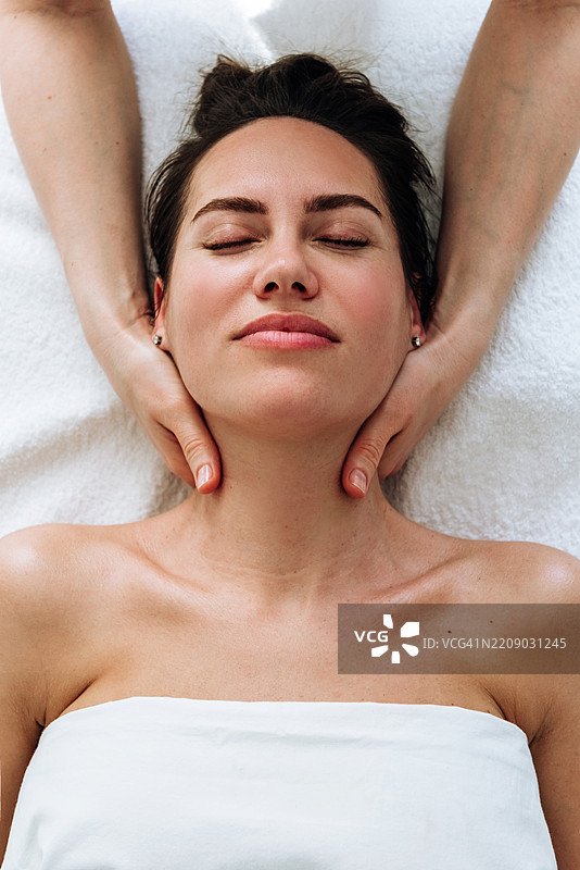 女性在面部和颈部按摩中放松图片素材