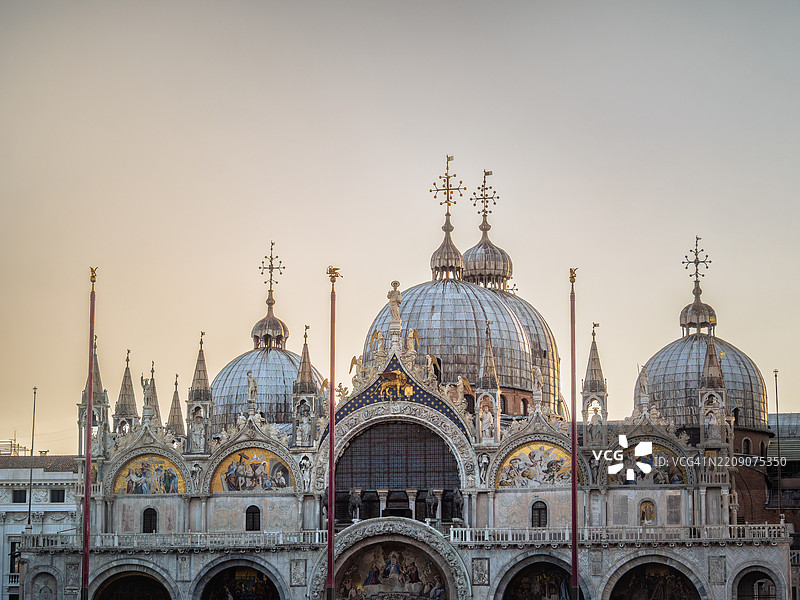 从圣马可广场（联合国教科文组织世界遗产）俯瞰著名的圣马可大教堂（圣马可大教堂）的正面，阳光在日出时分的金色时刻照耀着。图片素材