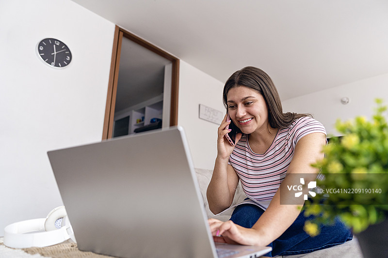 在家中使用笔记本电脑工作的男人。图片素材