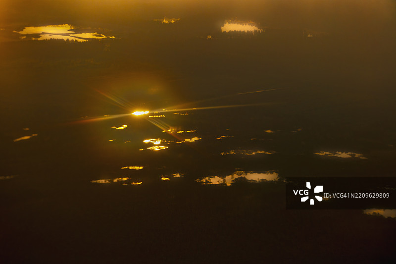 千湖之国 - 芬兰独特湖泊景观的航拍图，橙色日出时的森林晨曦图片素材