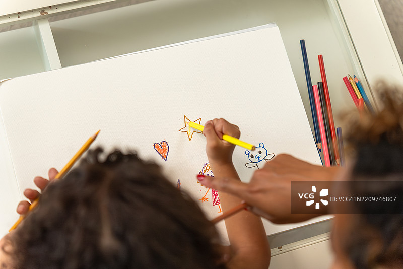 一幅色彩斑斓的画作描绘了一个童趣场景，画中有彩虹、猫、狗、泰迪熊，以及一个微笑的女孩，女孩的名字被标注在旁，周围环绕着心形和星星，展现了童年的想象力、创造力和快乐的表达。图片素材