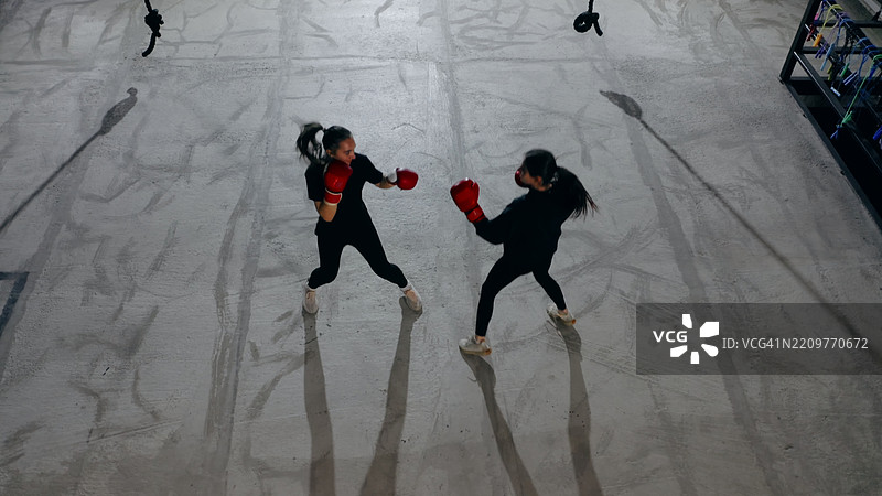 两名年轻女性运动员在健身房一起训练拳击图片素材