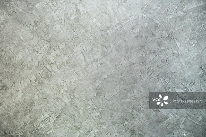 有纹理的水泥墙面，带有涂抹的油漆。装饰性的阁楼抹灰。图片素材