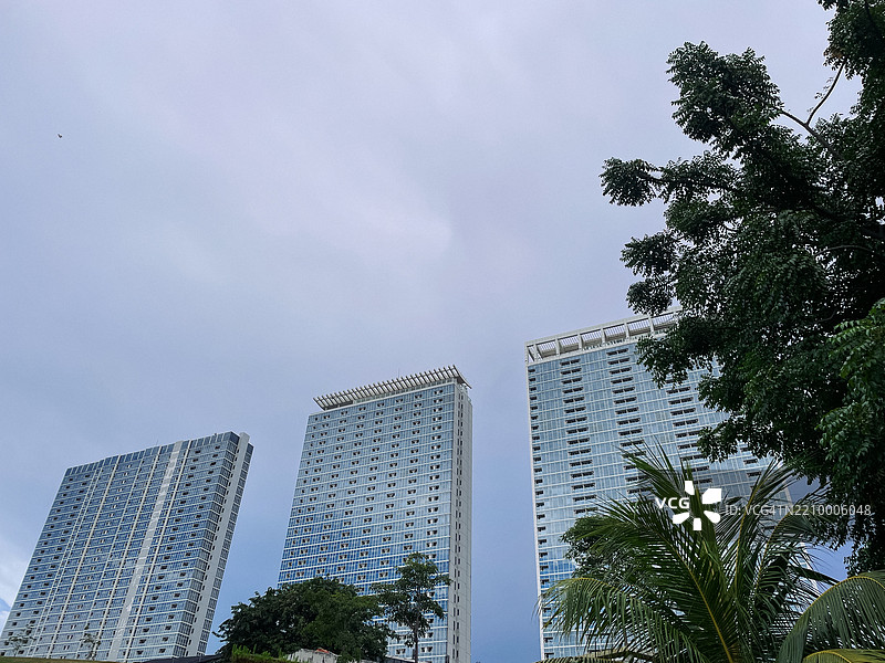 现代高层公寓建筑与阴云密布的天空图片素材