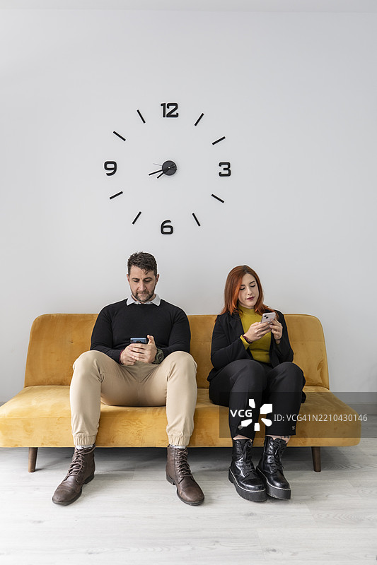 工人在候诊室的沙发上放松。办公室工作人员在休息。图片素材