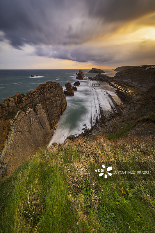 一束辉煌的光线笼罩着西班牙坎塔布里亚的乌罗斯德利恩克雷斯附近的悬崖。图片素材