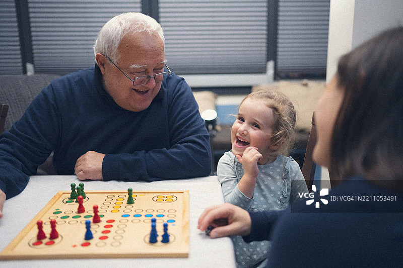 家庭关怀。玩桌游和分享家庭时光图片素材