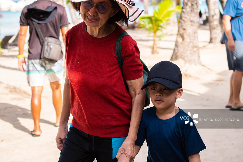 东南亚祖母和孙子在夏天的海滩上合影图片素材