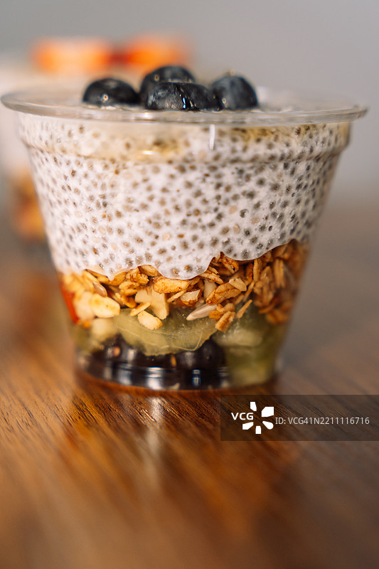 蓝莓和燕麦片的奇亚籽布丁装在塑料外卖杯中图片素材