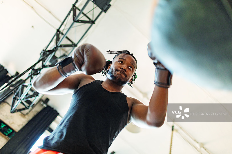 年轻男子在健身房进行拳击训练图片素材