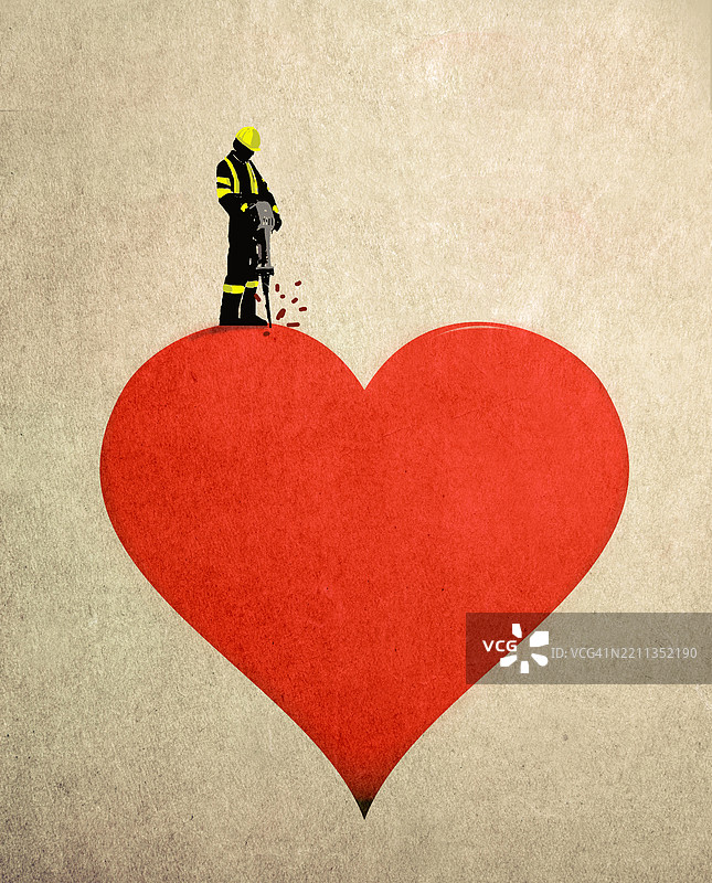 消防员使用电锤破坏象征心碎的心形图案图片素材