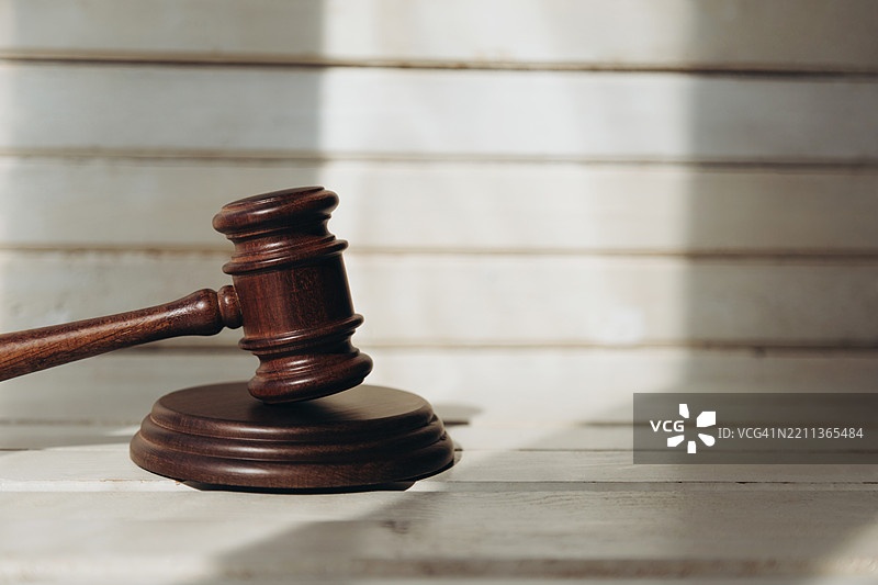 阳光下的声音块上放着棕色法槌，环境明亮。图片素材