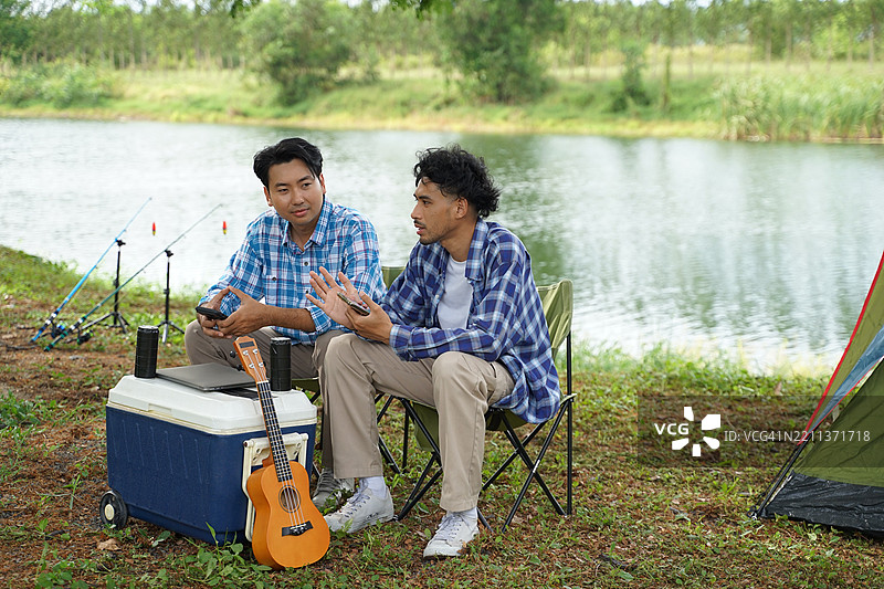 一个男人和他的朋友在假期去自然公园露营。图片素材