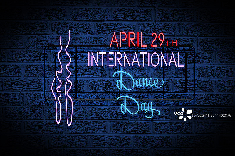 国际舞蹈日霓虹灯光在黑暗背景上。图片素材