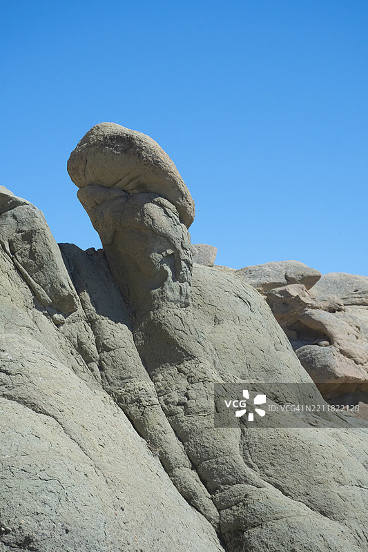 低角度视图下的岩石形成与晴朗的蓝天相映衬图片素材