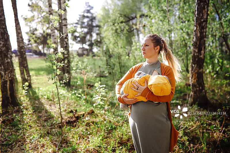 宁静的森林中，经验丰富的妈妈和满足的宝宝图片素材
