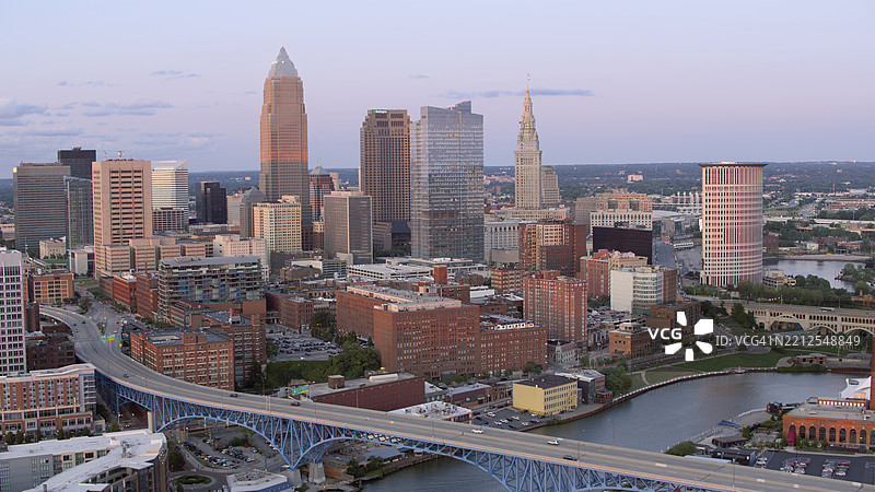克利夫兰市中心天际线与凯霍加河及历史建筑在黄昏时分的景色图片素材