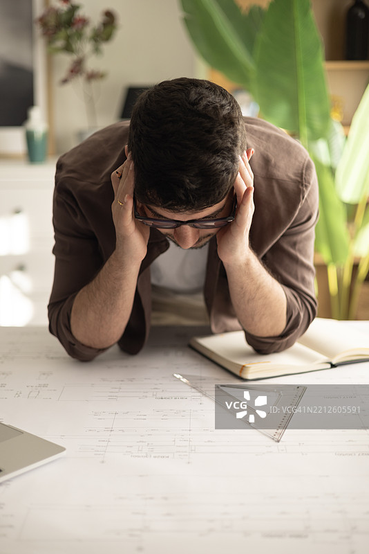 建筑承包商在家办公室分析计划。图片素材