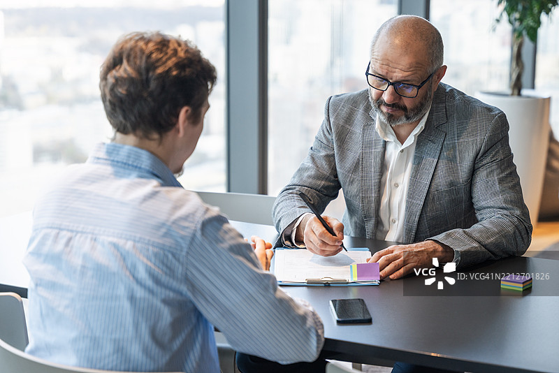 现代办公室桌子旁同事之间的工作面试或专业商务会议图片素材