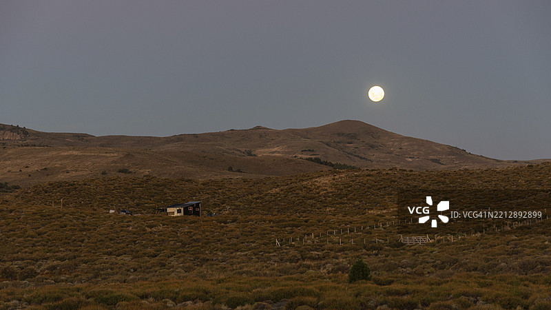 满月升起在阿根廷巴塔哥尼亚的胡宁德洛斯安第斯附近的草原上图片素材
