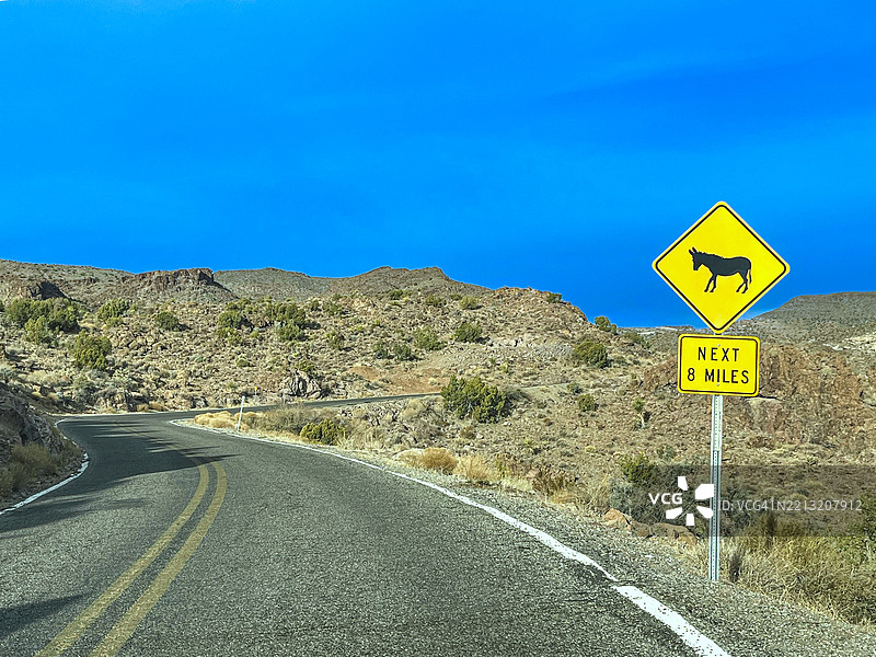在美国亚利桑那州的历史西部矿镇奥特曼附近的“66号公路”上，驴子过马路（“驴子过路”）警告标志图片素材