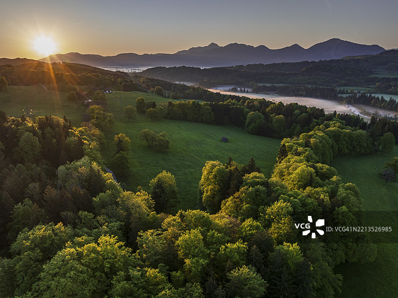 鸟瞰图，树木，森林，草地，浅绿色的叶子，晨光，雾气，山脉，阳光，日出，逆光，春天，靠近穆尔瑙，阿尔卑斯山脚，巴伐利亚，德国，欧洲图片素材