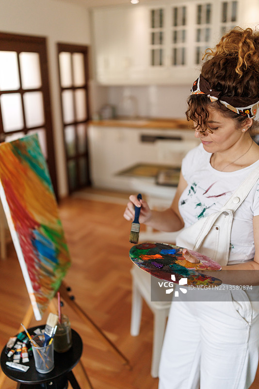 美丽的女性画家在家中创作图片素材