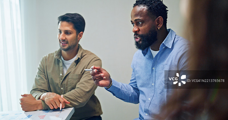 一群商业专业人士在办公室开会，审查大屏幕上展示的全球数据分析，讨论战略和增长。财务会议概念。图片素材